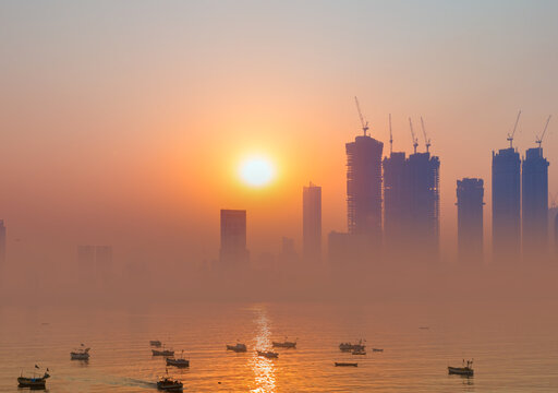 Air pollution concept - Modern highrise rich buildings and poor slums at sunset - Mumbai, india 