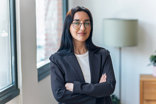 Elegant businesswoman posing and looking at camera in the office