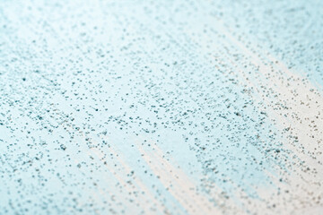 Obraz premium Blue pigment spread on gritty white surface macro view
