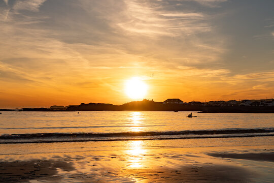 Paddle boarders at sunset at Trearddur bay Anglesey
