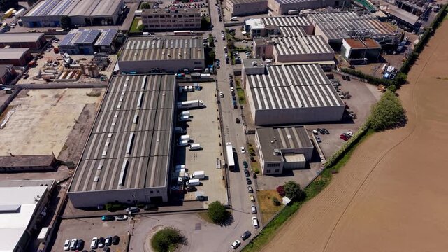 Industrial Complex: An aerial view reveals a sprawling industrial complex with numerous warehouses and manufacturing facilities, reflecting urban development and economic activity.