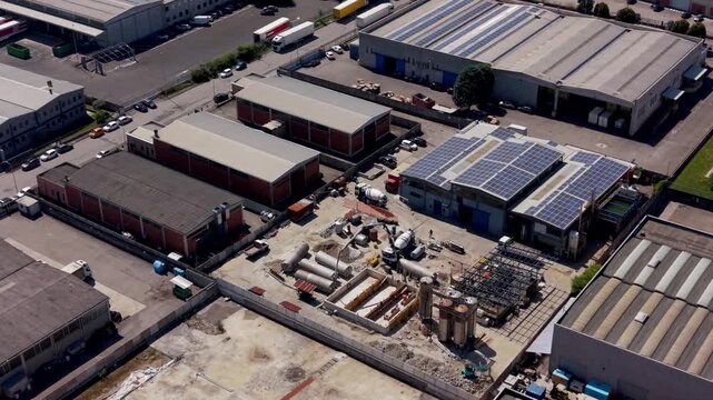 Aerial View of an Industrial Zone: An overhead perspective reveals a sprawling industrial complex with various warehouses, manufacturing facilities, and solar panels.