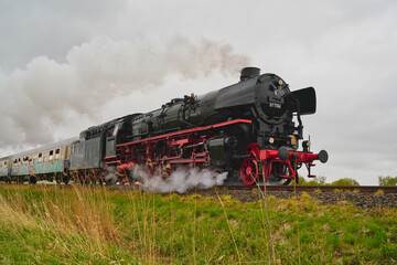 Fototapeta premium Type 01.10 steam engine with passenger train between Bremen and Cuxhaven