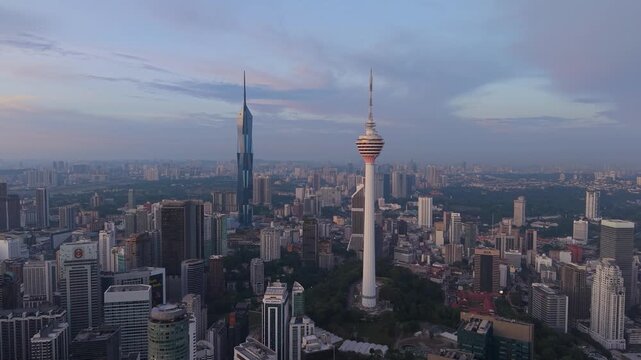 Kuala Lumpur, Malaysia - 04 April 2026: Aerial view of the KL Tower and Merdeka 118 skyscraper rising above the dense urban skyline under a soft twilight sky.
