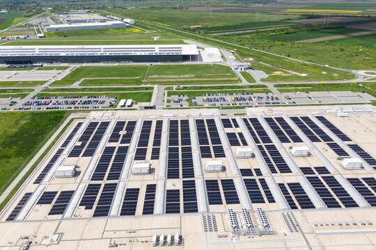 Aerial view of a modern logistics center with solar panels and energy storages on the roof