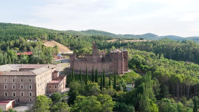 Majestic aerial view of the medieval javier castle in navarre, spain. Historic monument surrounded by lush green trees and rolling hills