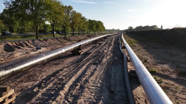 Industrial pipeline segments laid out on rural construction path