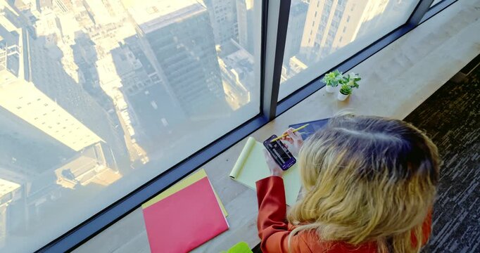 Woman Using Smartphone in High-Rise Office
