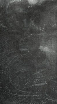 texture of blurred chalk residue on black paper, creating a soft, dusty, and artistic background with subtle gradients and organic patterns.