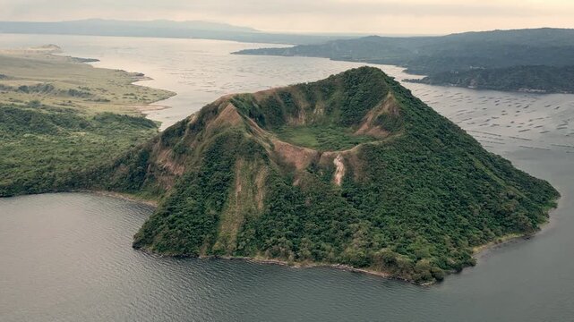 Volcanic Island Landscape. Serene Scene Of Isolated Volcanic Island With Lush Slopes And Rocky Boundaries