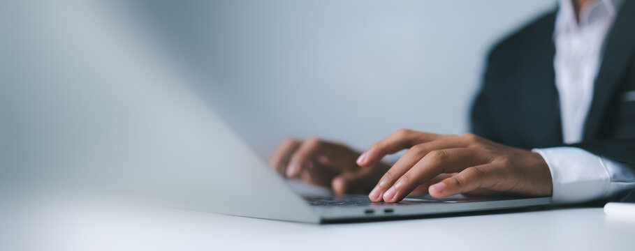 Businessman hands typing on laptop keyboard close up,Professional male employee working in modern office environment,Corporate digital communication and online networking concept.