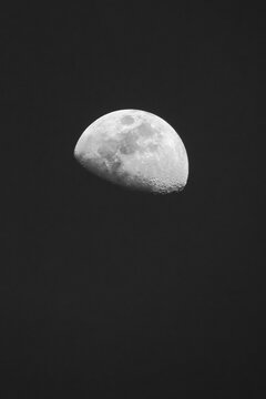 A sharp, telephoto astrophotography image of a waning gibbous moon against a deep black, texture-free night sky, highlighting intricate lunar craters and maria details.
