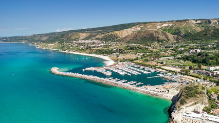 Obraz premium Drone perspective of Tropea in summer showing turquoise sea and scenic coastal landscape