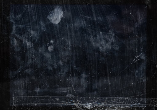 Close-up of a damaged tablet display with cracks, scratches, smudges, and visible tape repair. Dark abstract texture with distressed glass surface.