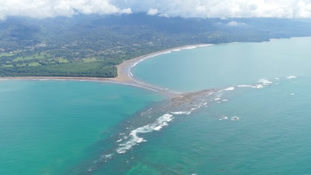 Stunning aerial perspective of the famous whale tail shaped sandbar at Marino Ballena National Park in Uvita, Costa Rica on a sunny day