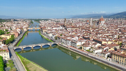 Fototapeta premium Drone aerial perspective Firenze Lungarni Arno River banks with Renaissance architecture colorful facades and Florence cityscape