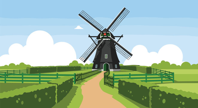 Classic black Dutch windmill standing in a lush green field surrounded by hedges and fences under a blue sky with clouds.