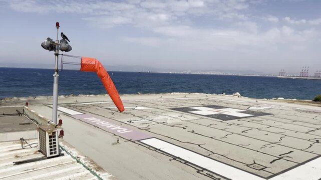 a windsock cone on a helipad near Rambam Health Care Campus in windy weather in Haifa, Israel