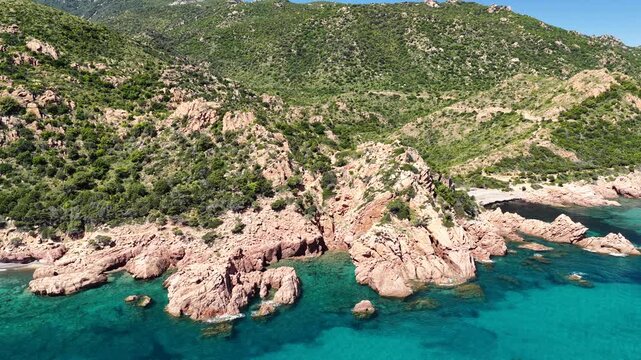 Aerial view of Su Sirboni Beach, Marina di Gairo, Sardinia, Italy. Turquoise sea, rugged red cliffs and hidden coves along the wild Ogliastra coastline