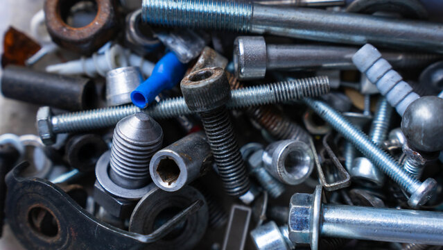 Metal bolts and nuts as industrial hardware background