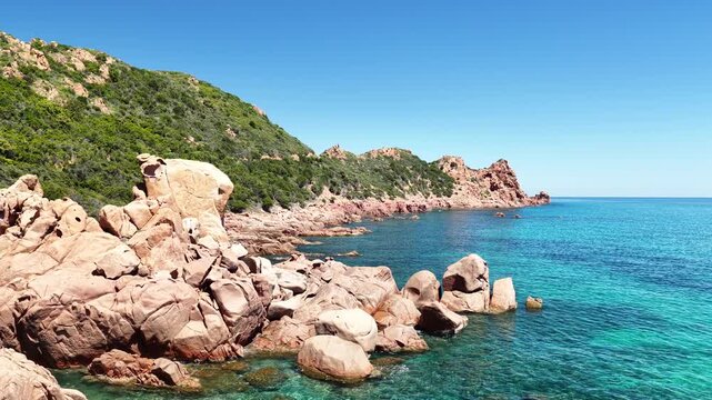 Aerial view of Su Sirboni Beach, Marina di Gairo, Sardinia, Italy. Turquoise sea, rugged red cliffs and hidden coves along the wild Ogliastra coastline
