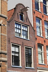 Fototapeta premium Amsterdam Kerkstraat Traditional Brick House Facade with Bell Gable Close Up, Netherlands