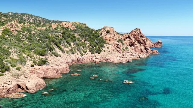 Aerial view of Su Sirboni Beach, Marina di Gairo, Sardinia, Italy. Turquoise sea, rugged red cliffs and hidden coves along the wild Ogliastra coastline