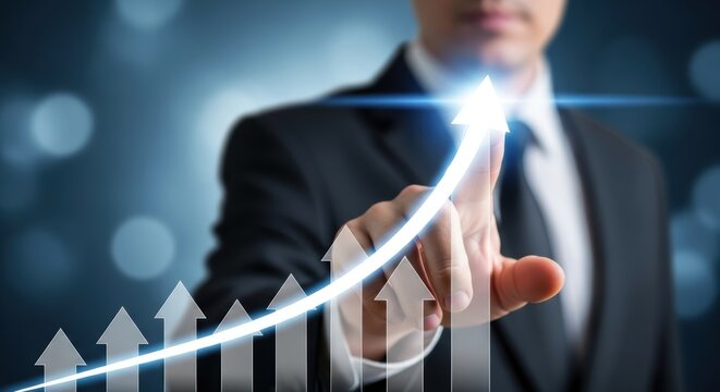 businessman pointing at glowing upward arrow on digital chart with blue background concept for business growth financial success strategic progress market rise investment and profit
