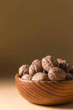 Whole Walnuts in Wooden Bowl Vertical