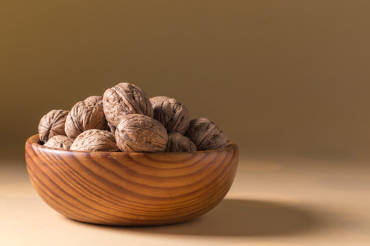 Whole Walnuts in a Wooden Bowl