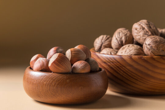Hazelnuts and Walnuts in Wooden Bowls