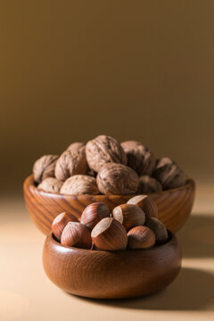 Stacked Wooden Bowls with Hazelnuts and Walnuts