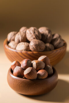 Close-up of Hazelnuts and Walnuts in Wooden Bowls
