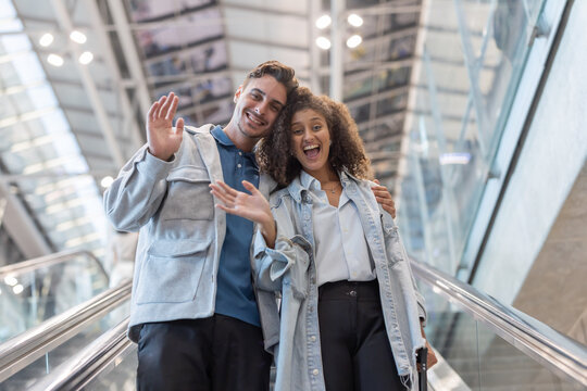 Couple wave hand to friends after arrive at the airport