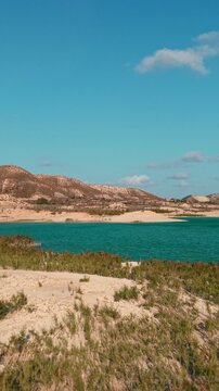 Aerial view of la pedrera reservoir with turquoise water and sandy shores in murcia