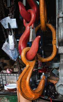 Red and Orange Hooks Hang in a Busy Workshop in the Afternoon