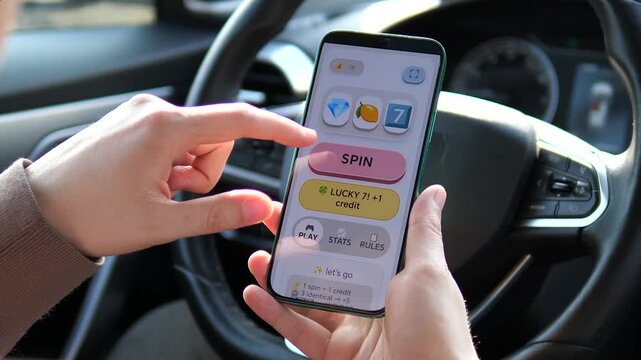 Close-up of male hands playing a lucky slot machine game on a smartphone in a car. User taps the spin button on a professional game UI. Ideal for mobile gaming marketing, gambling app reviews, and