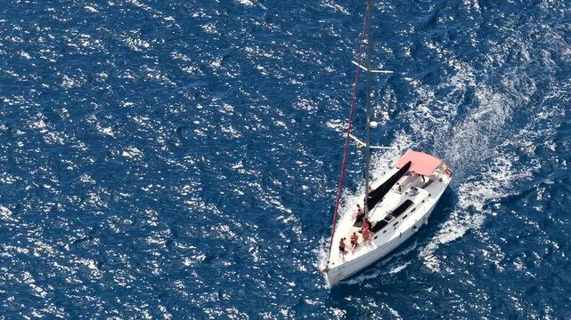 Aerial View of Playa de las Americas and Los Cristianos; Sailboats Anchored in Turquoise Bay with people swimming at the beach