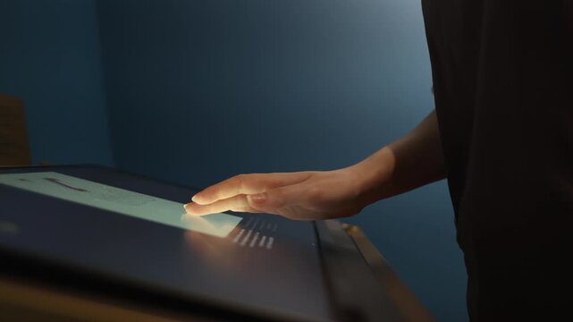 Navigation modern system. Woman's hand uses touch panel on terminal. Concept of futuristic interaction device