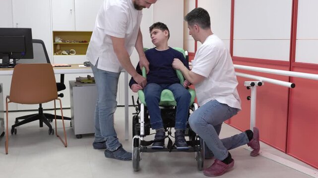 Orthopedic technicians customizing wheelchair for disabled child