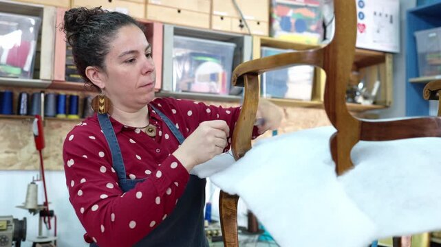 Professional upholsterer restoring an antique wooden chair