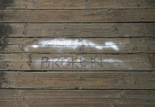CAUTION BROKEN plank on boardwalk