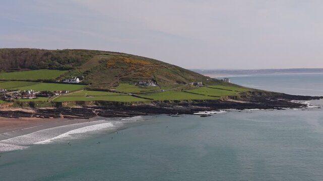 Aerial drone footage of Croyde Beach in North Devon, England, showcasing a sandy shoreline, rolling waves, and a popular surfing destination along the Atlantic coast