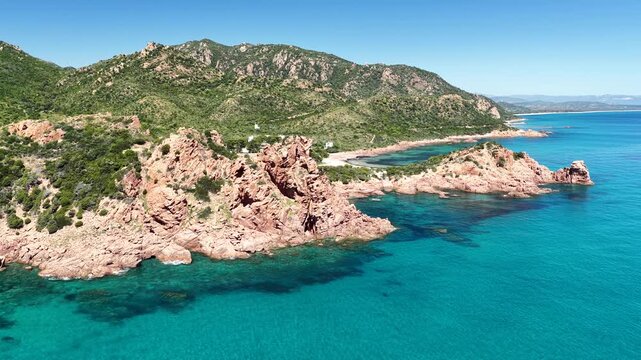 Aerial view of Su Sirboni Beach, Marina di Gairo, Sardinia, Italy. Turquoise sea, rugged red cliffs and hidden coves along the wild Ogliastra coastline