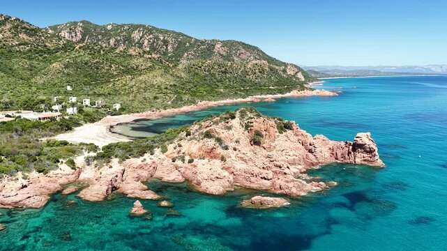Aerial view of Su Sirboni Beach, Marina di Gairo, Sardinia, Italy. Turquoise sea, rugged red cliffs and hidden coves along the wild Ogliastra coastline