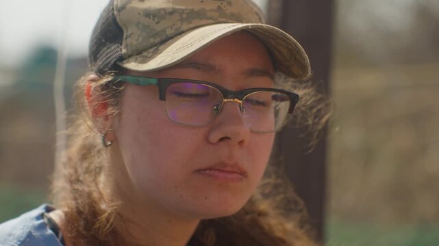 Woman Enjoying Grilled Kebab First Bite, Closeup Mouth And Hand, Wearing Cap And Glasses, Savoring Texture And Flavor, Sunlight Rim Light, Satisfied Expression, Casual Outdoor Dining Scene