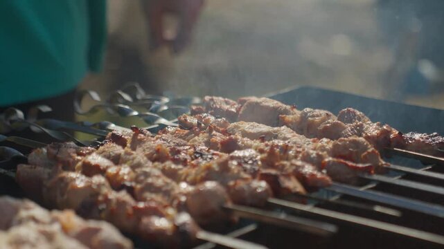 Expert Flips Produce Crispy Edges. Skilled Chef Flips Skewers To Attain Crispy Golden Sides Precisely. Expert Hands Carefully Turn Skewers Over Hot Grill To Create Beautifully Crisp Edges