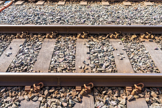 Railway tracks with rails, sleepers, and ballast stones