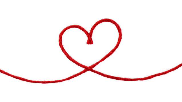 Red string forming a heart shape on a plain surface