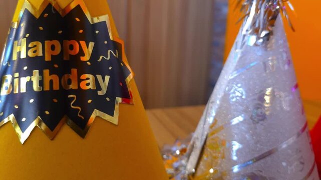 Birthday party hats standing in a row for a celebration on a wooden table in a bright room 4k Footage